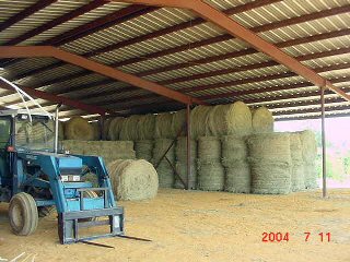 Loading photo of round bales in the barn...