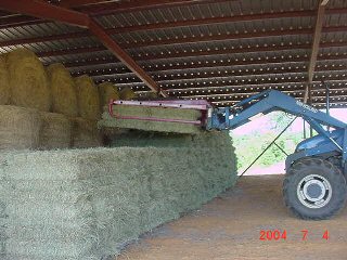 Loading photo of square bales in the barn...