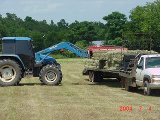 Loading photo of square bales being loaded on trailer...